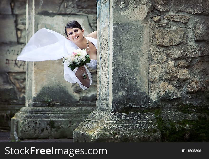 Beautiful bride posing among old church walls