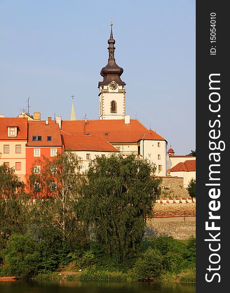 The colorful medieval town Pisek in Czech Republic with gothic deanery Church above the river Otava