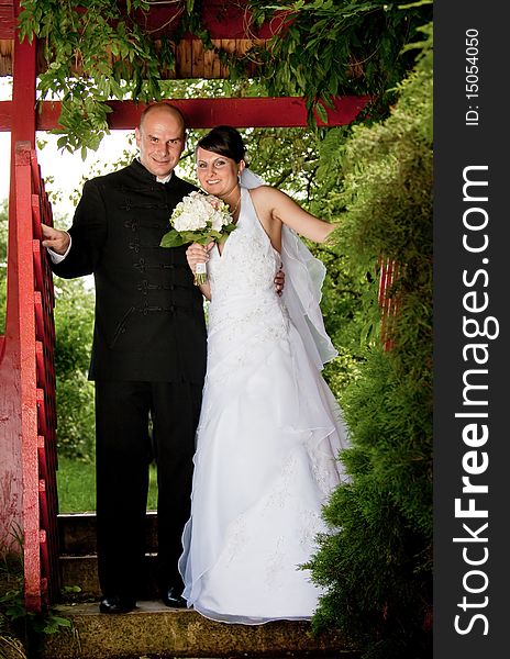 Bride and groom opening red fence