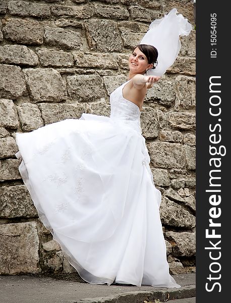 Beautiful bride posing among old church walls