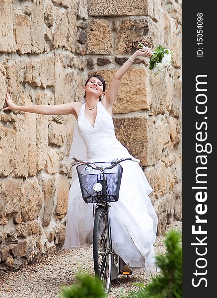 Happy bride riding on a bike