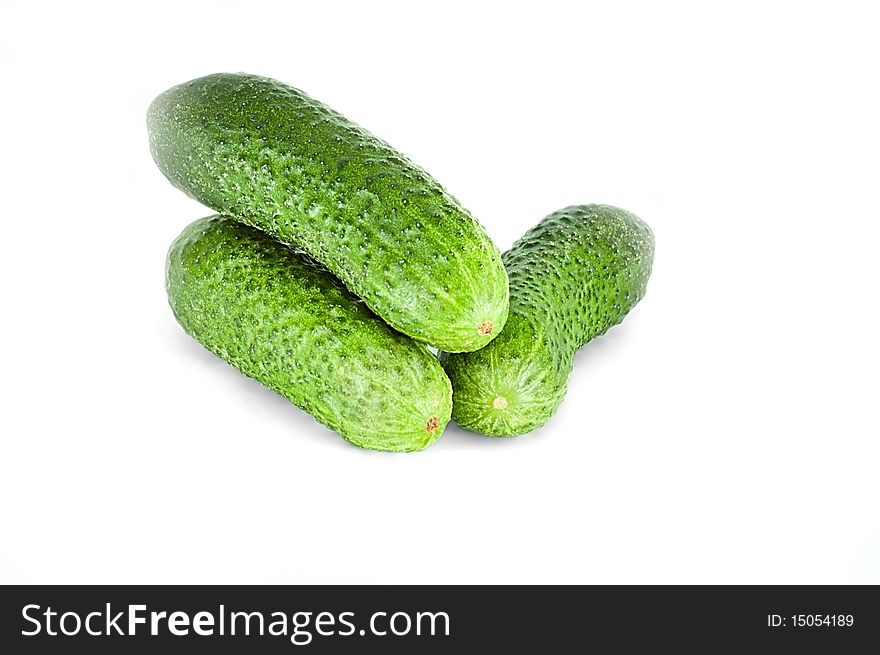 Three green cucumbers, isolated on the white background