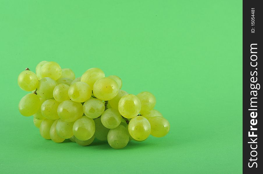 Fresh ripe green grape on green background