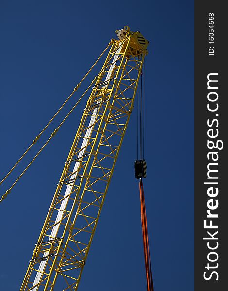 Mobile crane against dark blue sky