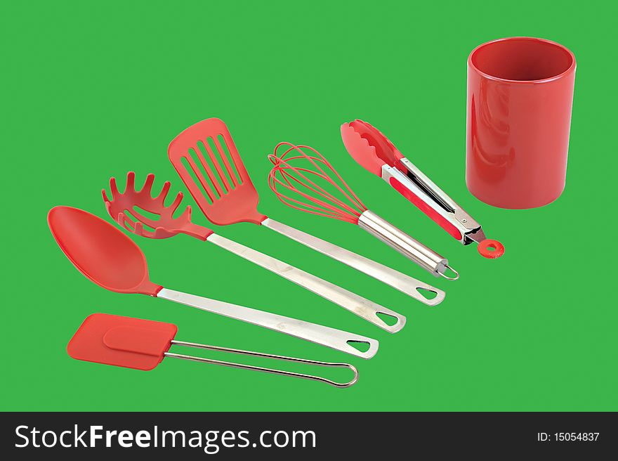 A set kitchen utensils on green background. A set kitchen utensils on green background