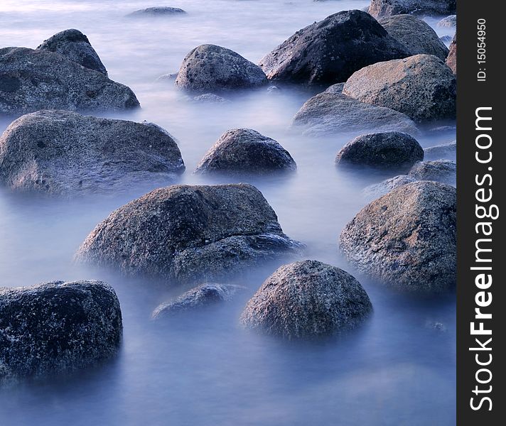 Rocks on shoreline in water and mist. Rocks on shoreline in water and mist