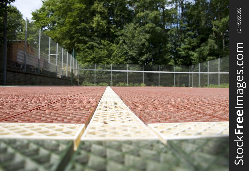 Tennis court set in a forest