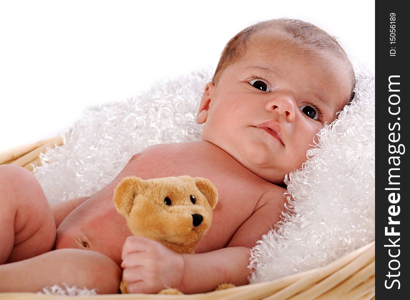 Close-up of a newborn in a fluff-lined blanket clutching a small brown teddy bear.  Isolated on white. Close-up of a newborn in a fluff-lined blanket clutching a small brown teddy bear.  Isolated on white.