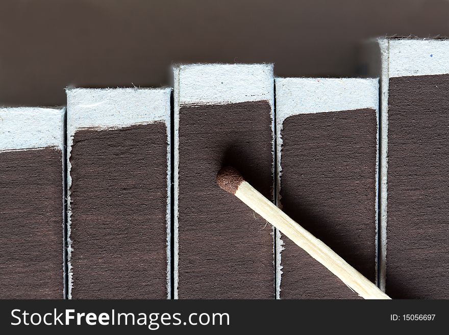 One match lying on few matchboxes. Extreme closeup. One match lying on few matchboxes. Extreme closeup