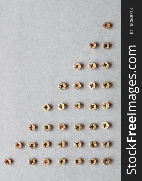 Gray background made from lot of brass screws. Gray background made from lot of brass screws