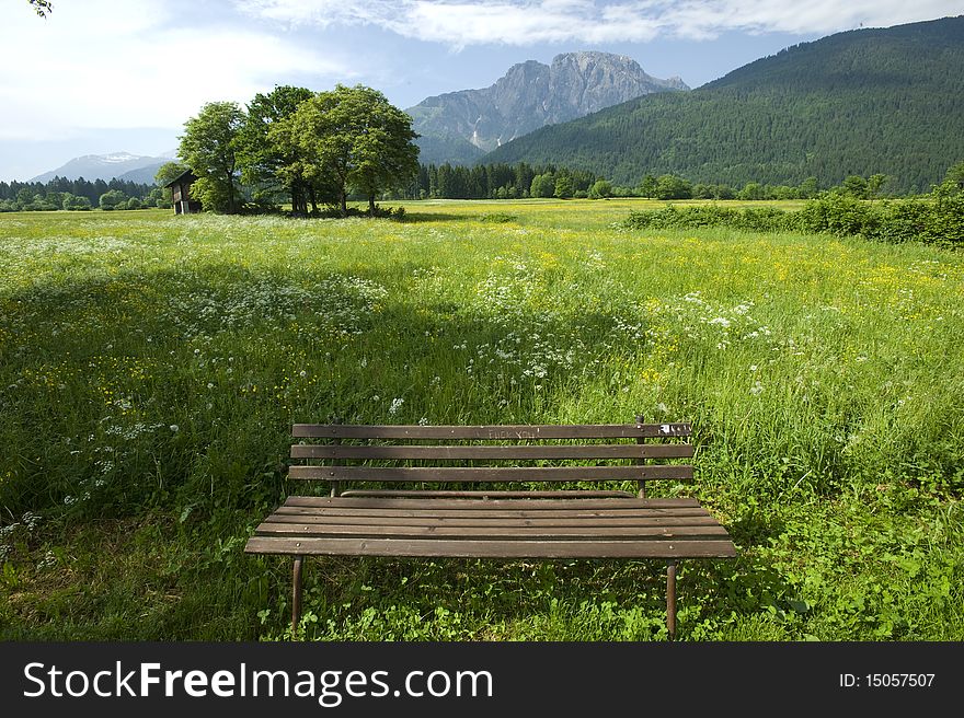 Wooden bench on beautiful mountain background; Austria. Wooden bench on beautiful mountain background; Austria