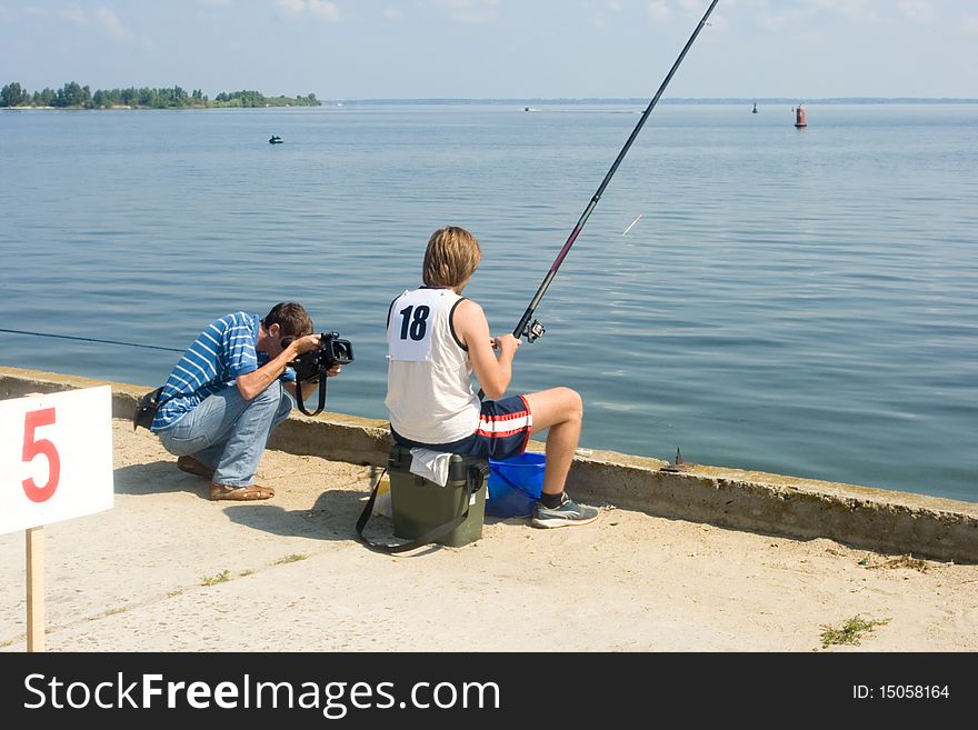 Competition for fishing the bait. operator takes a video about competing in fishing for the bait. Competition for fishing the bait. operator takes a video about competing in fishing for the bait.