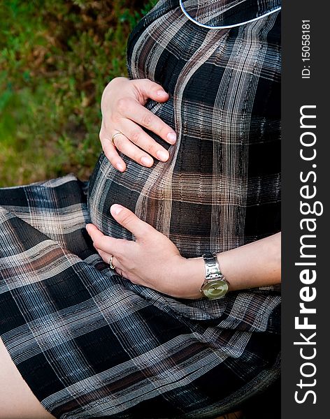 Pregnant woman in the park. Outdoor shot. Pregnant woman in the park. Outdoor shot