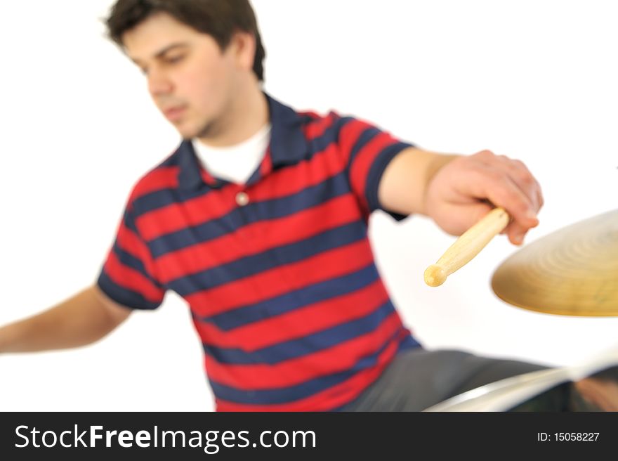 Young drummer playing in studio with wite background