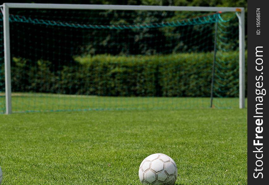 Soccer ball in front of goal on soccer field