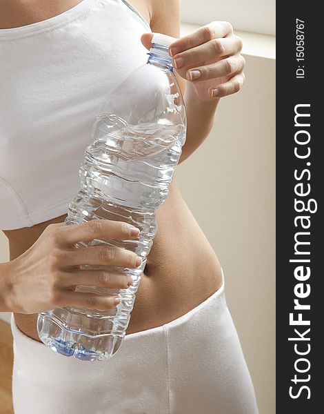 Young woman drinking water after exercise. Young woman drinking water after exercise