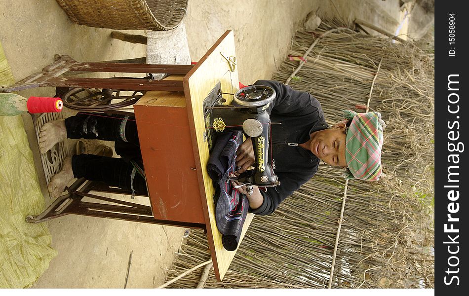 Black Hmong woman sewing machine