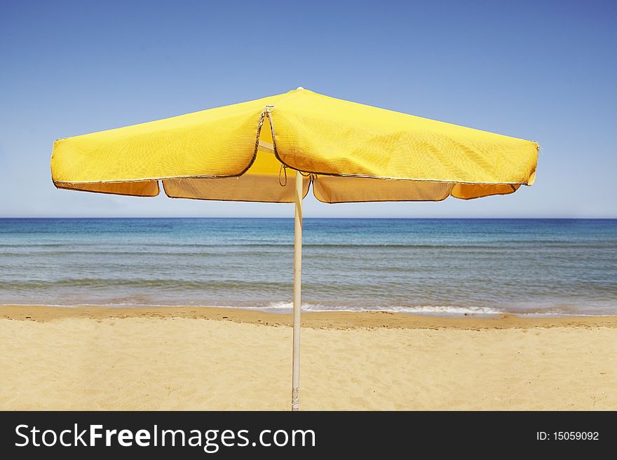 Yellow sun umbrella on  a  Beach