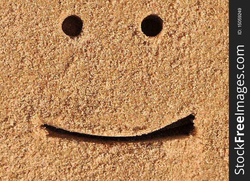 Draw of face on fine sand. Draw of face on fine sand