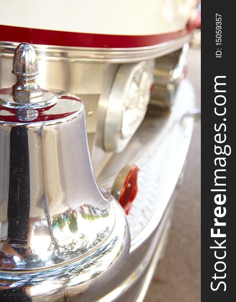 A fire bell photographed on a old fire truck.