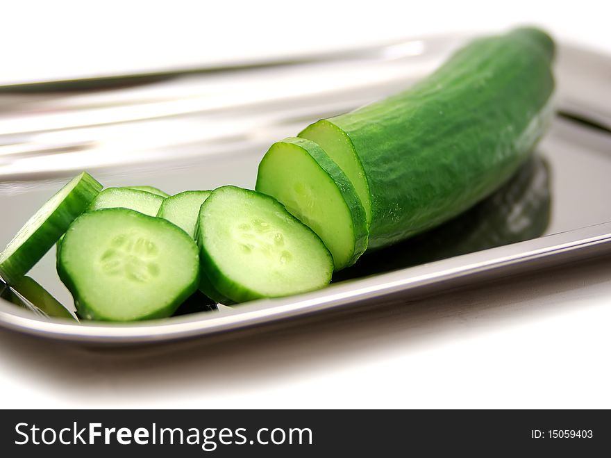 Sliced green cucumber in a tray