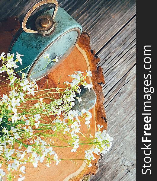 Wild fresh flowers in porcelain jug, old clock on blue wooden background. Daylight, vivid colors. Still life in rustic style. Countryside lifestyle, holiday, vacation concept. Selective focus Top view. Wild fresh flowers in porcelain jug, old clock on blue wooden background. Daylight, vivid colors. Still life in rustic style. Countryside lifestyle, holiday, vacation concept. Selective focus Top view