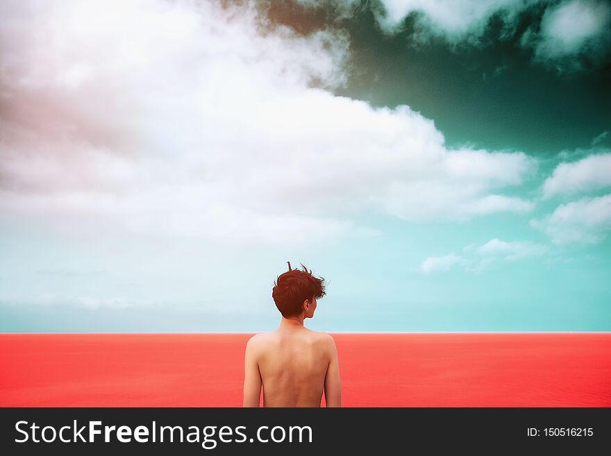 Slim Girl With A Beautiful Bare Back Is Standing On The Living Coral Sea. Dark Sky With Clouds. Unity With Nature. Freedom. Life