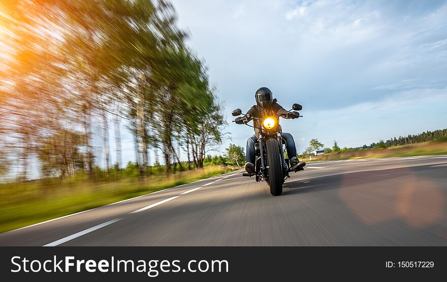 Motorbike on the road driving fast. having fun on the empty highway on a motorcycle  journey. copyspace for your individual text. Motorbike on the road driving fast. having fun on the empty highway on a motorcycle  journey. copyspace for your individual text