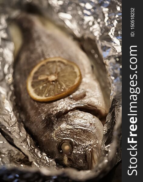 Fish baked in foil with lemon. Close-up