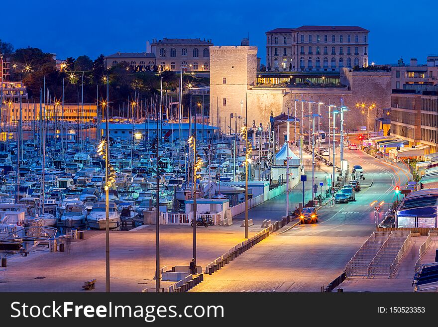 Old port and city embankment in night lighting. Marseilles. France. Old port and city embankment in night lighting. Marseilles. France.