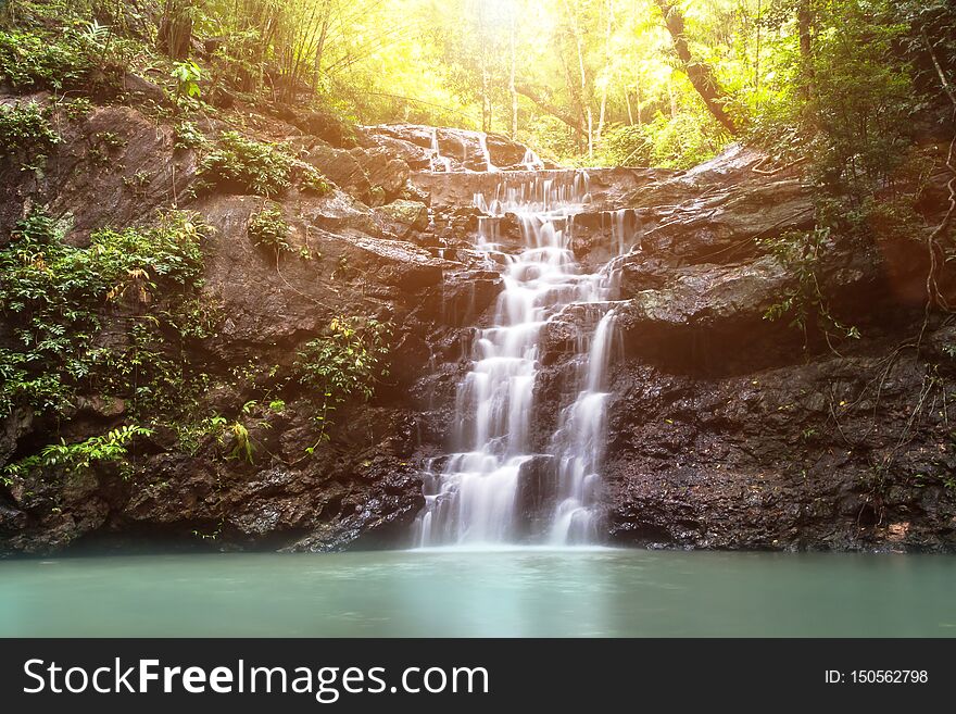 beautiful small waterfall in the wild with sun light,nature