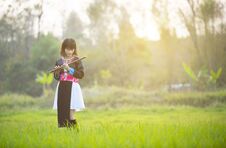 Tribe Asian Lady Girl In Custom Dress Hand Hold Flute With Happy Face Walking In Rice Field In Monsoon Period Stock Photos