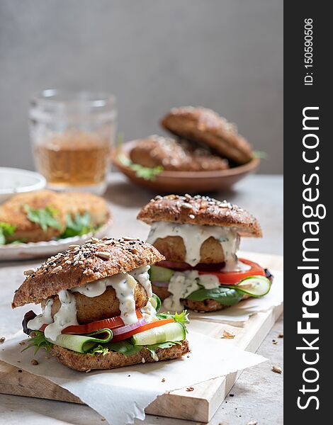 Fish seafood burger with mayo and fresh vegetables
