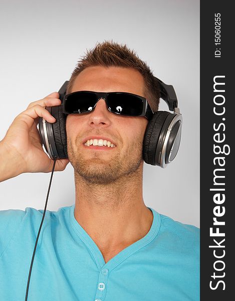 Portrait of young man with headphones, smiling happy. Portrait of young man with headphones, smiling happy.