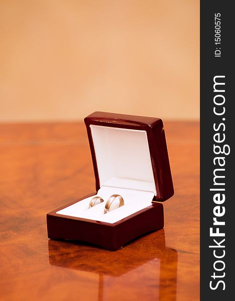 Two gold wedding rings in a box on the table