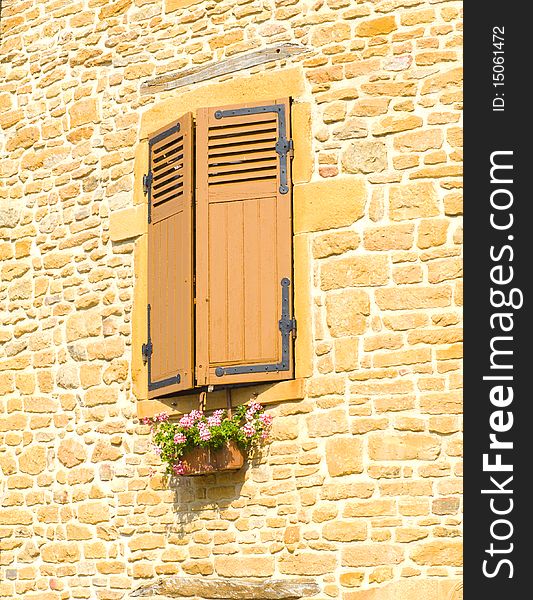 Closed windows with flower box in France