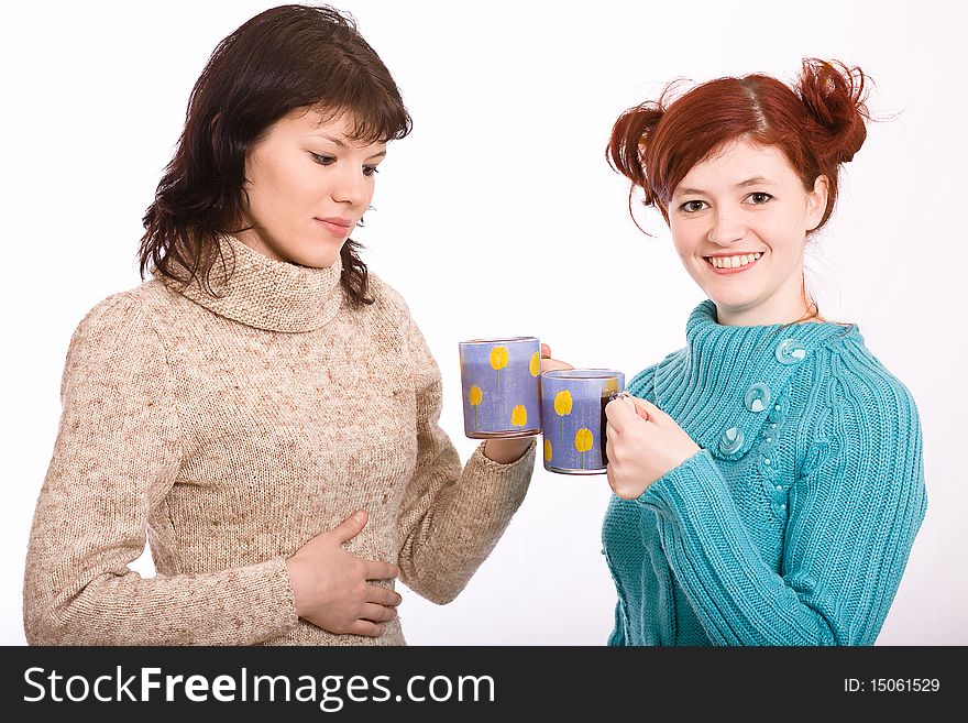 Two young beautiful girls drink coffee. Two young beautiful girls drink coffee