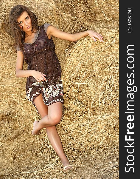 Young beautiful attractive woman in a haystack