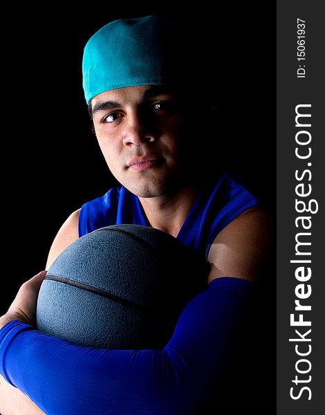 Young teenage basketball player in a studio setting with hip athletic clothing. Young teenage basketball player in a studio setting with hip athletic clothing.