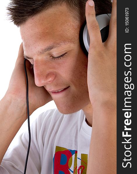 Young fresh teenager with headphones isolated over a white background. Young fresh teenager with headphones isolated over a white background.