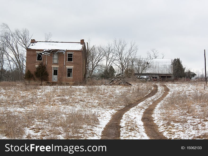 Abandoned farmhouse beside one lane road. Abandoned farmhouse beside one lane road.