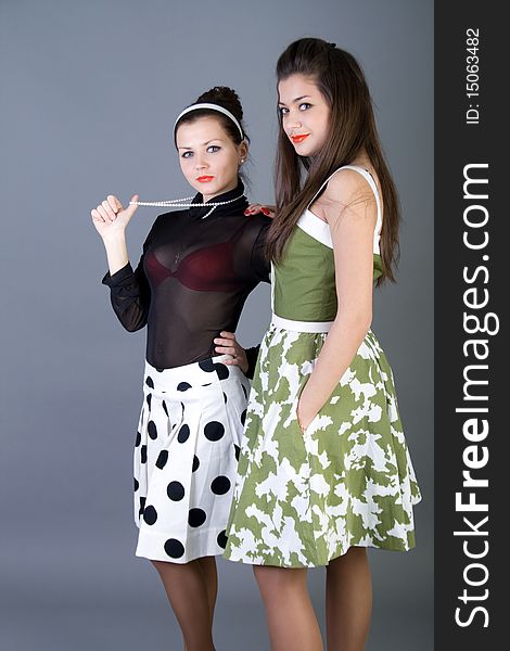 Two  happy retro-styled girls studio shot