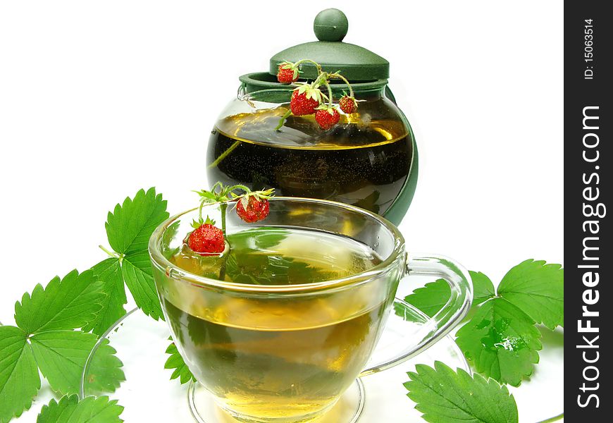 Herbal tea with with wild strawberry in cup and teapot. Herbal tea with with wild strawberry in cup and teapot