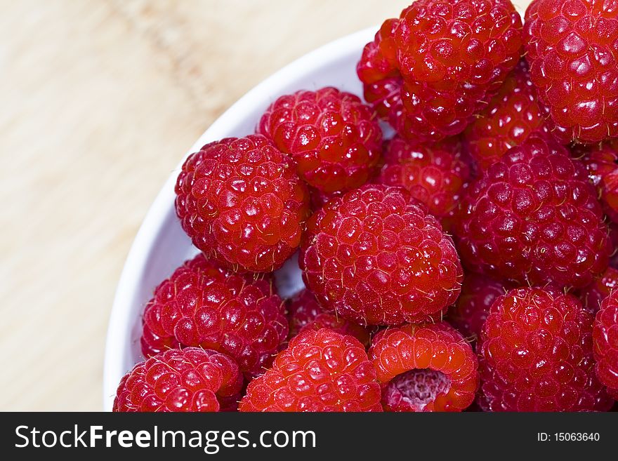 Raspberries in a white bowl top view