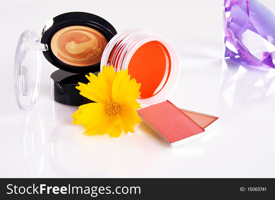 Cosmetics With A Yellow Flower And Violet Crystal