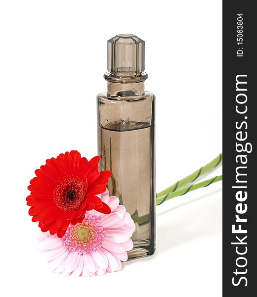 Perfume flask with flowers isolated on white background