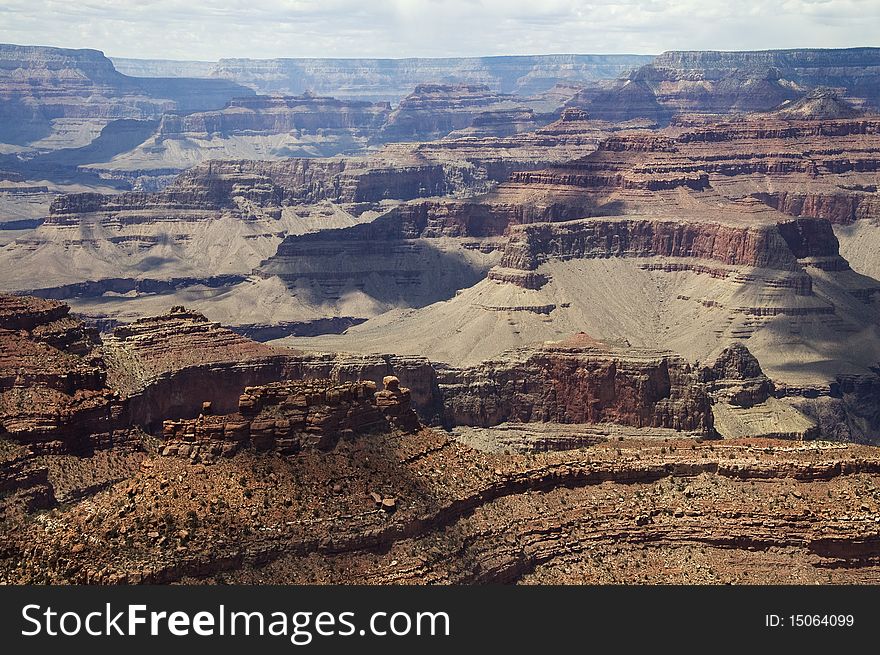 Scenic view of the cloud shadows over the Grand Canyon on a sunny day. Scenic view of the cloud shadows over the Grand Canyon on a sunny day.
