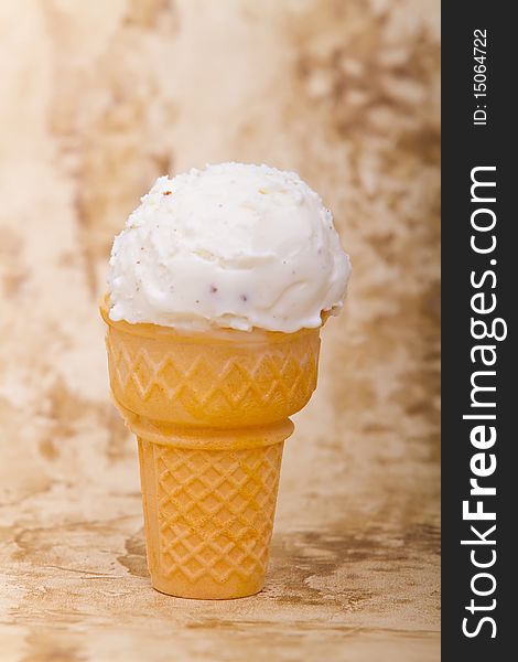 Scoop of vanilla ice cream in ice cream cone. Scoop of vanilla ice cream in ice cream cone