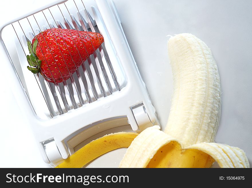 Slicing strawberries and bananas for breakfast. Slicing strawberries and bananas for breakfast.