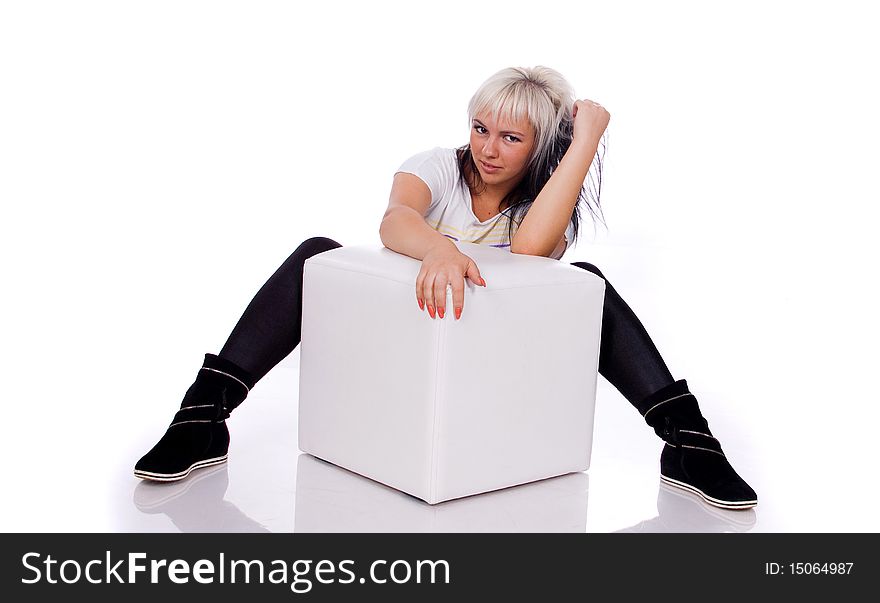 Teenage lady with the ottoman on a white background. Teenage lady with the ottoman on a white background